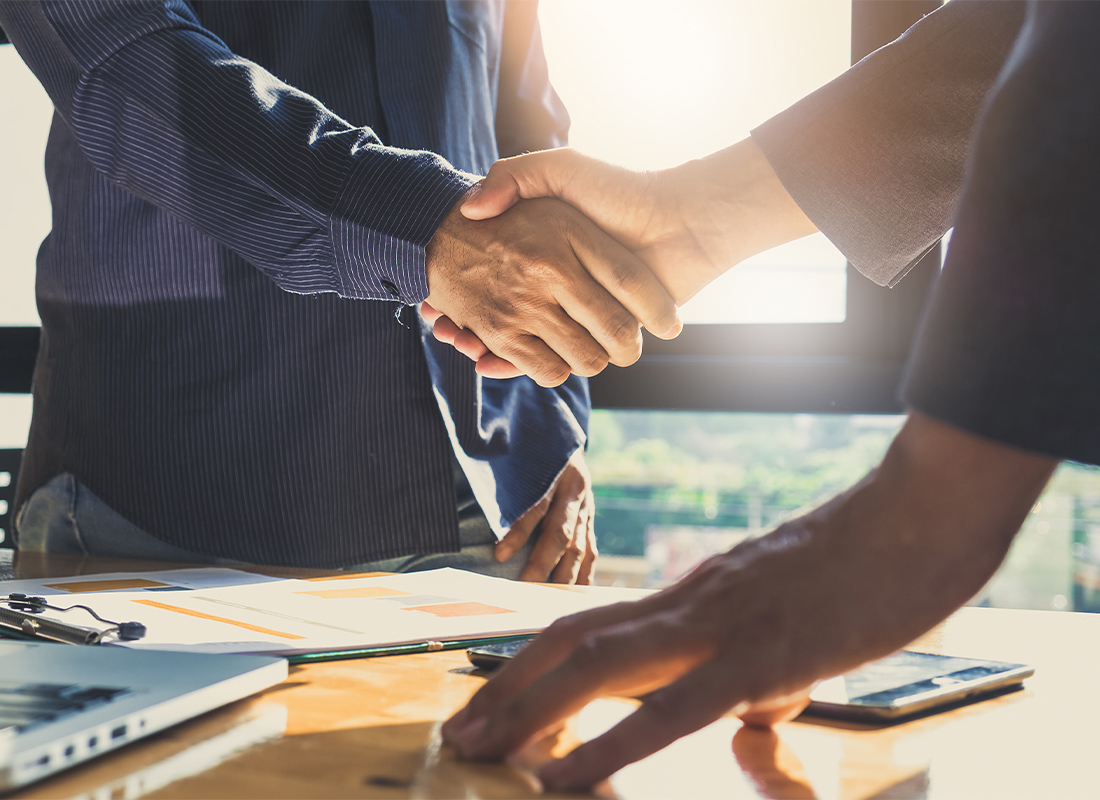Acquistions - Two Business Men Shaking Hands After a Successful Meeting