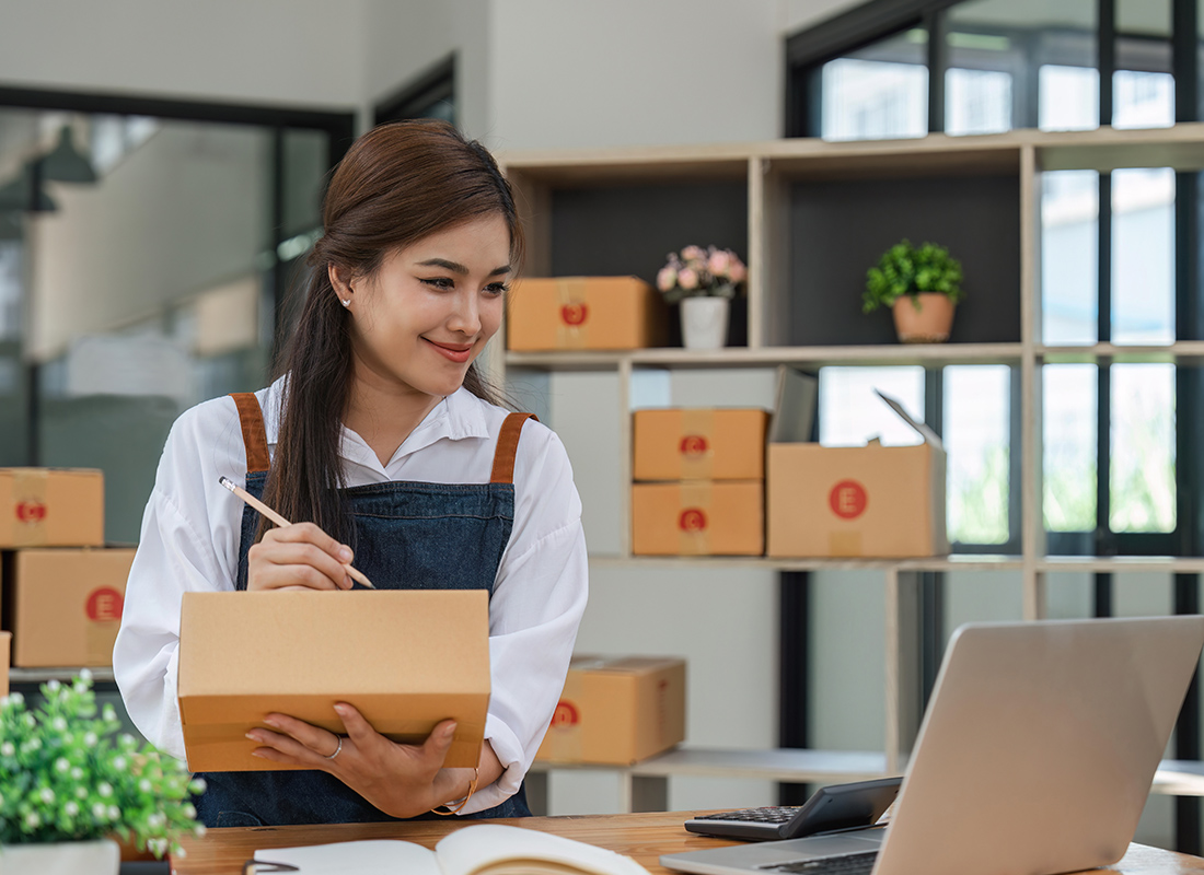 Business Insurance - Business Owner Checking Inventory in Her Office