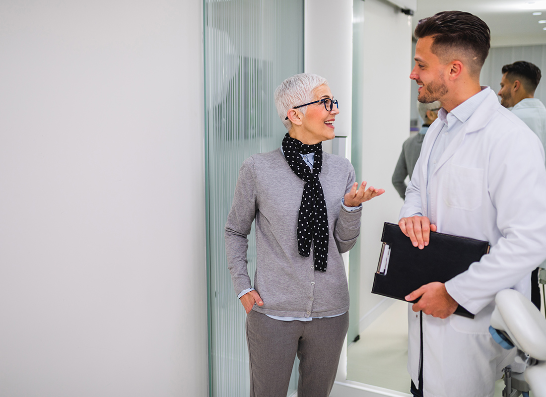 Insurance by Industry - Woman Speaking With a Doctor in an Office